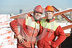 Happy builder workers at construction site