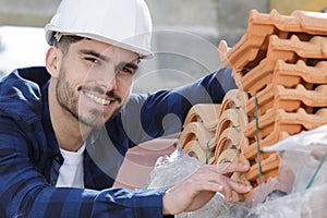 happy builder working on roof new building