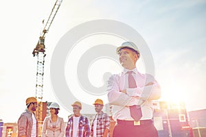 Happy builders and architect at construction site