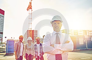 Happy builders and architect at construction site