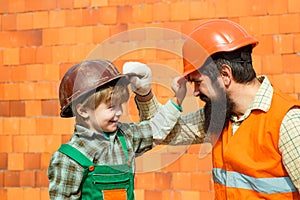 Happy builders. Protective helmets. Occupational Safety and Health. Family at a construction site. Own house. The