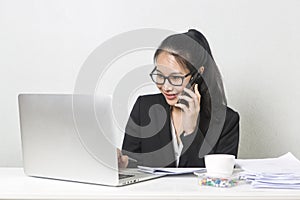 Happy business Asian woman working with laptop at white working table