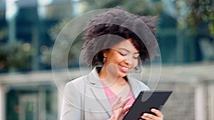 A happy business consultant reading a joke on her digital tablet. Young woman reading her work emails. Female chatting