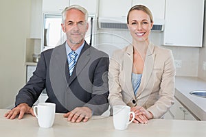 Happy business couple having coffee before work in morning