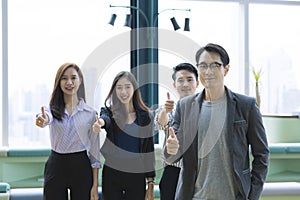 Happy business group giving thumbs up. Businessman and Businesswoman thumbs up in Co Working Space