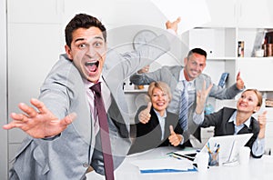 Happy business group with smiling man at office