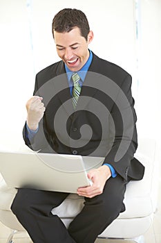 Happy business male on laptop