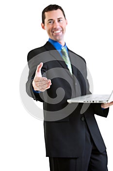 Happy business male on laptop gesturing handshake