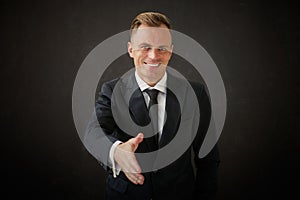 Happy business man extanding his hand for a shake