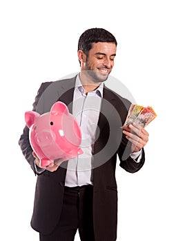 Happy business man holding piggy bank with Australian Dollars