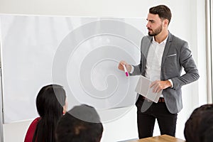 happy business man making a presentation on whiteboard . boss presenting strategy of marketing to goal of success with teamwork in