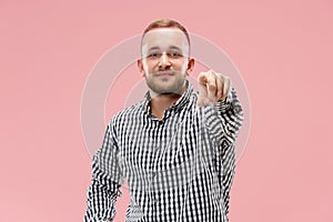The happy business man point you and want you, half length closeup portrait on pink background.