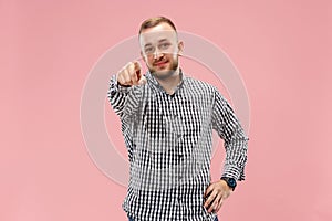 The happy business man point you and want you, half length closeup portrait on pink background.