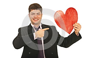 Happy business man pointing to heart