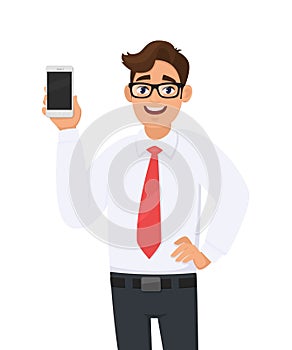 Happy business man showing a new brand, latest smartphone. Young man holding blank screen cell or mobile phone in hand.