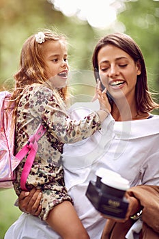 Business mother taking child to primary school