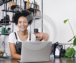 Happy business owner standing at counter