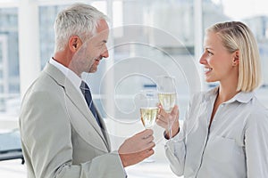 Happy business partners celebrating with champagne