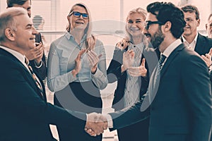 happy business partners shaking hands. the concept of cooperati photo