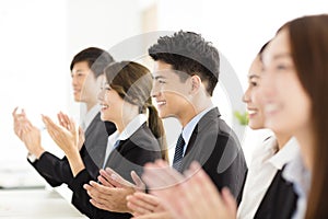 Happy business people applauding in conference