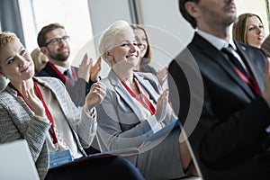 Happy business people applauding during seminar