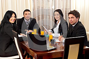 Happy business people around a table at meeting