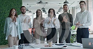 Happy business people clapping hands during seminar, success and achievement concept