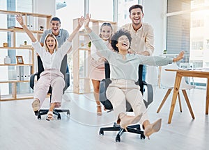 Happy business people doing office games with chair at work, celebration of success and freedom at startup company and