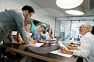 Happy business people having fun and chatting at workplace office