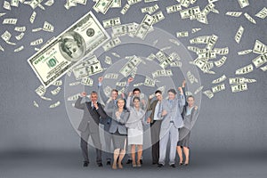 Happy business people with money rain against grey background photo