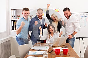 Happy business people team celebrate success in the office photo