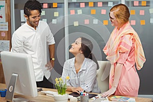 Happy business people using computer in office