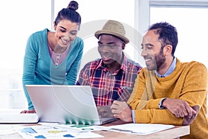 Happy business people working on laptop