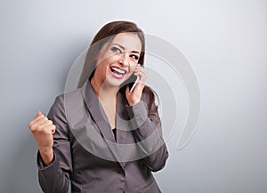 Happy business successful excited woman talking on mobile phone