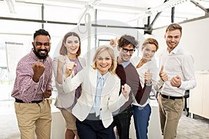 Happy business team celebrating victory at office