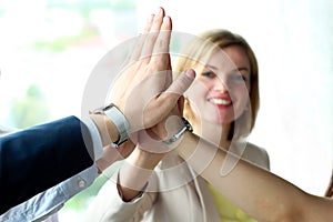 Happy business team giving high five in office