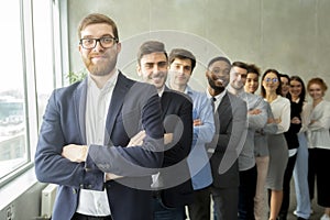 Happy business team headed with boss standing in row