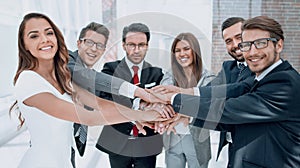 happy business team joining hands together