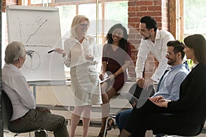 Happy business team listen old mentor give flip chart presentation