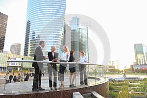 Happy business team members talking outside in .