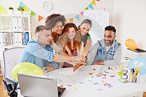 Happy business team at office party holding hands