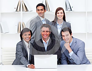 Happy business team working at a computer