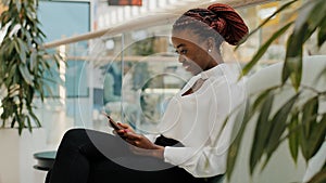 Happy business woman african american girl worker manager young female sitting in corridor office modern creative