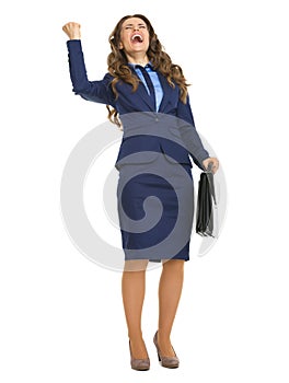 Happy business woman with briefcase rejoicing success