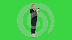 Happy business woman enjoy success on mobile phone on a Green Screen, Chroma Key.