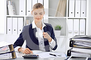 Happy business woman or female accountant having some minutes for time off and pleasure at working place. Audit and tax