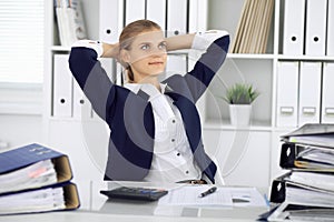 Happy business woman or female accountant having some minutes for time off and pleasure at working place. Audit and tax