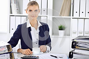 Happy business woman or female accountant having some minutes for time off and pleasure at working place. Audit and tax