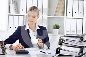 Happy business woman or female accountant having some minutes for time off and pleasure at working place. Audit and tax