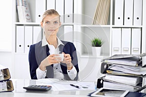 Happy business woman or female accountant having some minutes for time off and pleasure at working place. Audit and tax